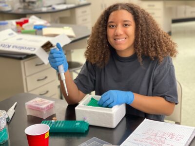 Young female biology research student in a lab